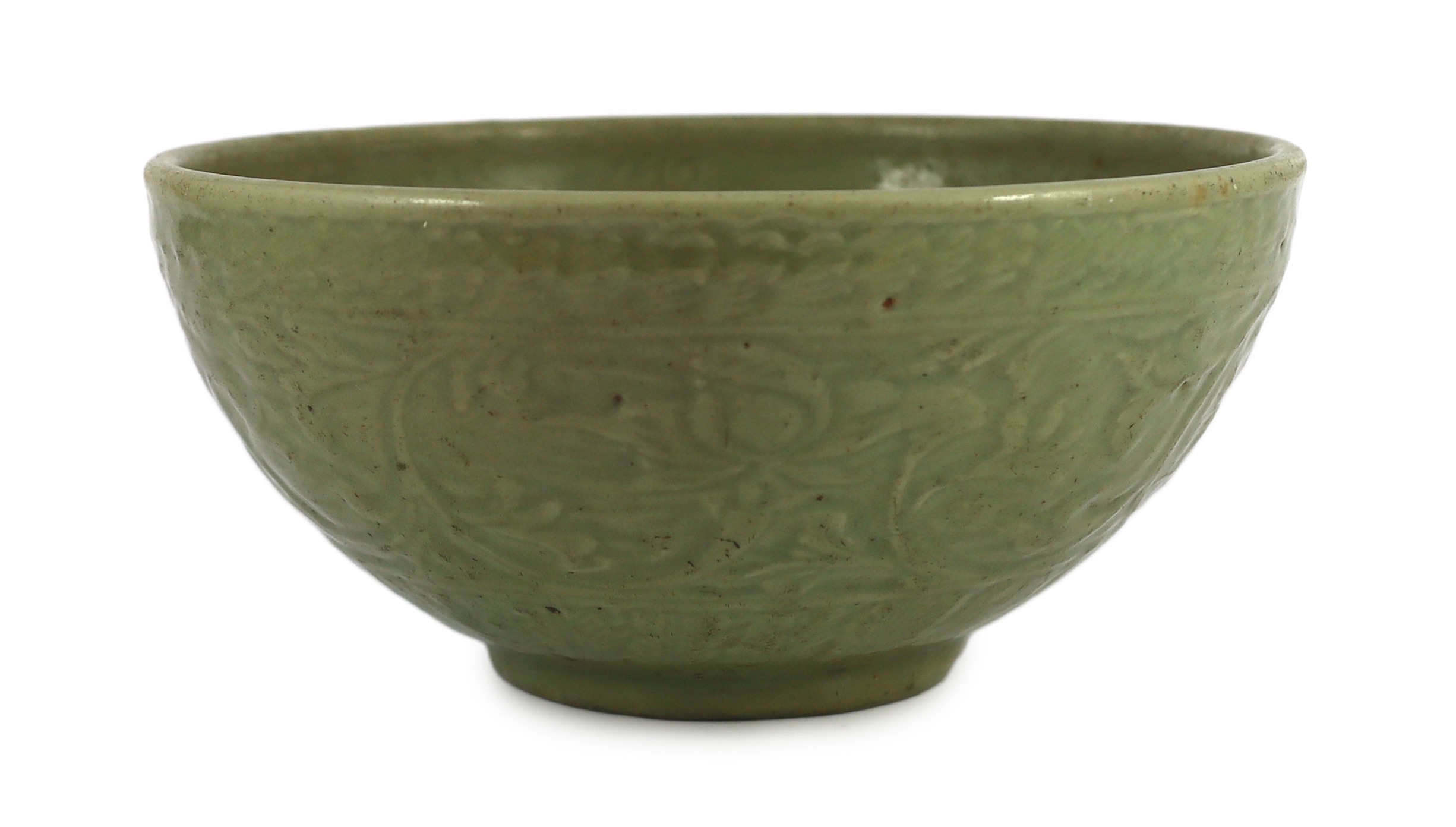 A large Chinese Ming carved Longquan celadon deep bowl, first half 15th century, scratches to glaze